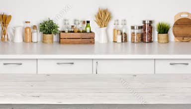 Empty wooden table with bokeh image of kitchen bench interior