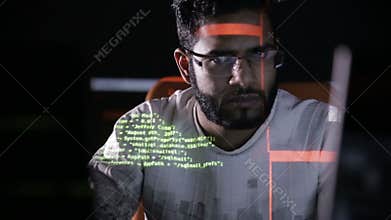 Arabic IT specialist working on computer at night. Hacker breaking computer code.