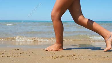 Bare legs little girl dancing water edge