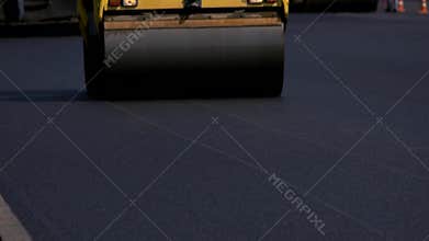 Motion of asphalt compactor.