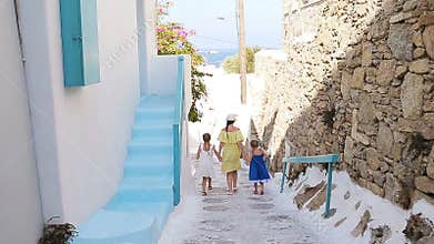 Family vacation in Europe. Mother and little girl in european vacation in greek town