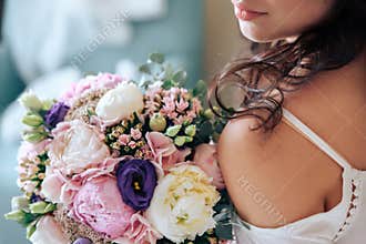 Bride holding a bouquet of flowers in rustic style, wedding