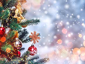 Christmas tree background and Christmas decorations with snow, blurred, sparking, glowing. Happy New Year and Xmas