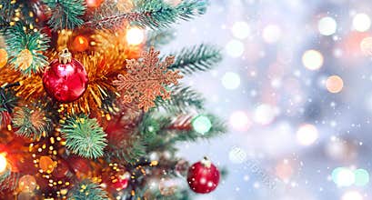 Christmas tree background and Christmas decorations with snow, blurred, sparking, glowing. Happy New Year and Xmas