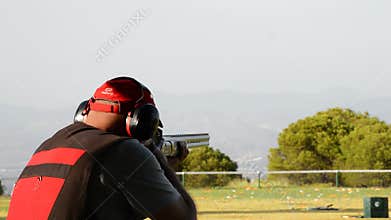 Shooter man firing a rifle in skeet championship