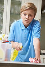 Unhappy Boy Helping to Clean House