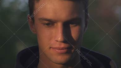 Cunning teenager smiling into camera, plotting something bad, adolescence