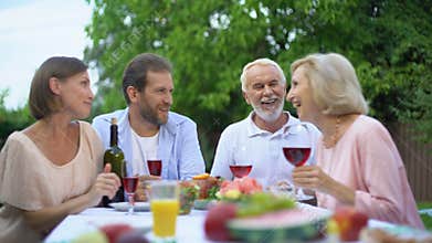 Family chatting while dining, young and old generation connection, relations