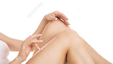 Young woman touching silky skin on legs after epilation, isolated on white background. ckin care concept