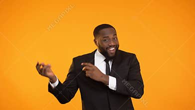 Afro-american male in business suit dancing, presentation advertisement, webinar