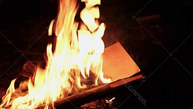 A girl is burning a letter.