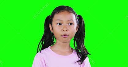 Adorable girl chewing gum in the studio