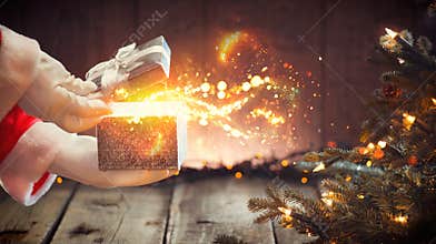 Christmas scene. Santa Claus opening box with magic gift