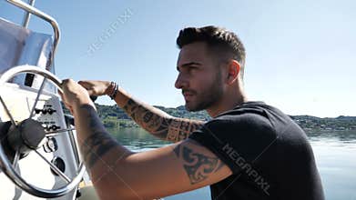 Alluring tattooed man in boat
