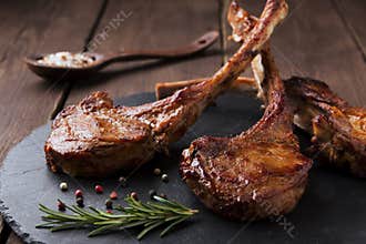 Roasted lamb ribs loin chop on a stone surface