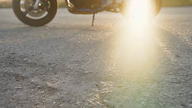 Male legs walks to the motocycle on the road. 4K
