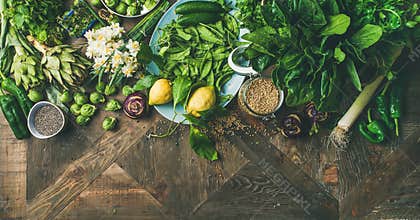 Spring healthy vegan food cooking ingredients, wooden background, wide composition