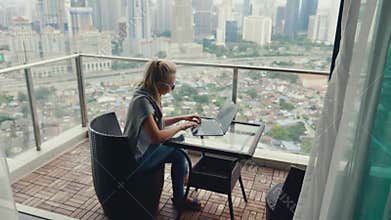 Beautiful Woman Working on Balcony