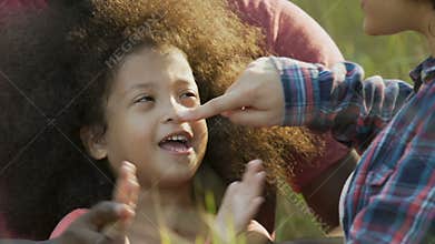 Parents playing with adopted daughter in garden, outside weekend, recreation