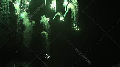 Stunning fireworks flowers on the night sky. Colorful rain showers of fireworks on the dark night background. Festive event.