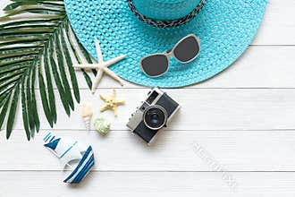 Summer Fashion, camera, starfish, sunblock, sun glasses, hat. Travel and vacations in the holiday, wood white background