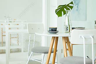 A cup of coffee is placed on the table. And flowers in a vase, coffee shop. Image use for food and beverage
