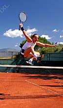 Girl jumping tennis net
