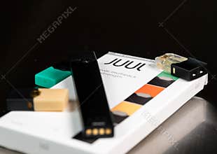 Box holding JUUL nicotine dispenser and pods