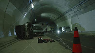 Car accident scene inside a tunnel, firefighters rescuing people from cars