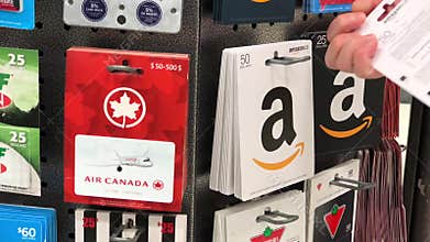 Motion of woman picking fifty dollars Amazon gift card