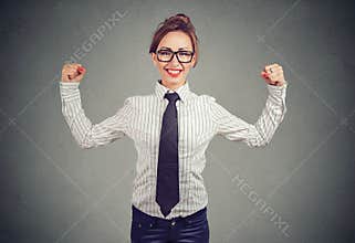 Strong business woman showing biceps