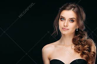 Waist up portrait of charming brown-haired with professional delicate makeup. Attractive female posing at studio in