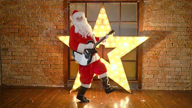 Santa Claus rock star, plays christmas songs by guitar, have fun, celebrate holidays