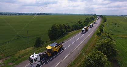 Aerial view. Transportation of combines on road tractors on the road. Oversized transportation. 4k