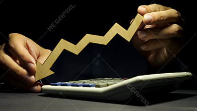 Man is holding arrow in the hands as a symbol. Increase or reduce in business.