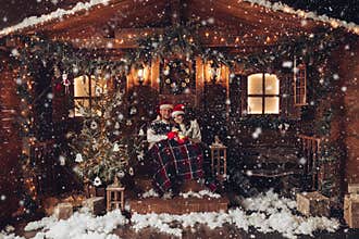 Christmas romance in Santa Claus hats beautiful house New Year`s atmosphere