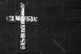 Christian cross on a dark gray wooden surface