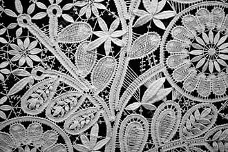 Lace doily on black background, close up