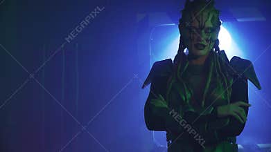 Scary alien with white eyes is wearing armor and standing with crossed arms, 4k