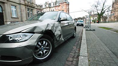 Luxury BMW German car parked city street damaged car accident insurance