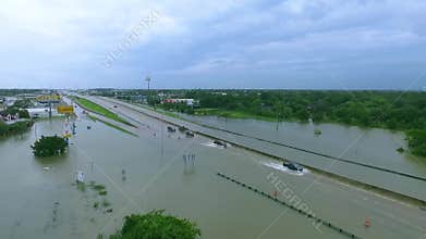 Cars and trucks trying to drive through flooded i45 near Houston Texas