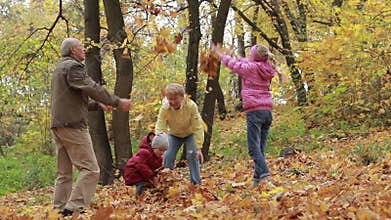 Grandparents and kids having fun in autumn park