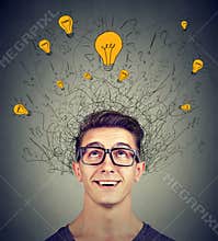 Brain connections. Excited man looking up at many ideas light bulbs above head. Eureka concept