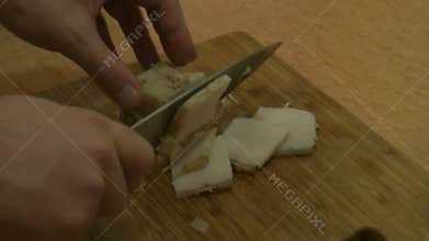 Male hands slicing lard. Russian cuisine.