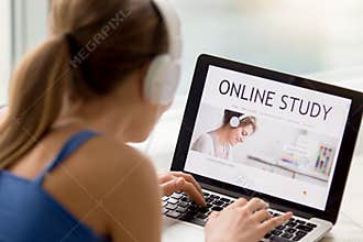 Online study concept, young woman wearing headphones searching a