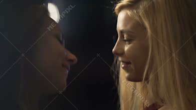 Passionate female petting girlfriend gently, lesbian couple dancing to music