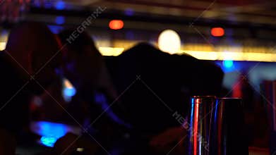 Man in suit ordering drinks at bar counter, celebrating alone relaxed atmosphere