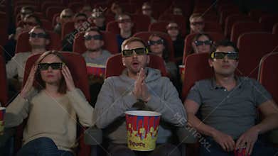 People wearing 3d movie glasses in cinema. Movie entertainment