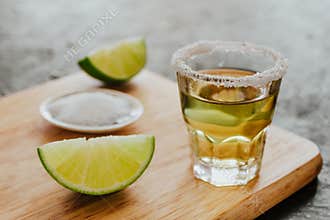 Tequila shot, mexican Alcoholic strong drinks and pieces of lime with salt in mexico