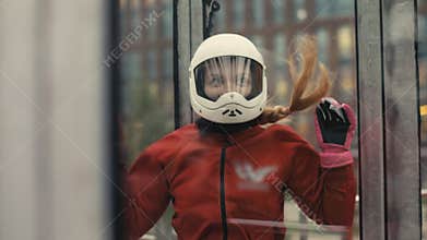 Young skydiver woman getting ready for flight in wind tunnel